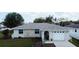 A bright single-story home with a stone facade, an arched entry and an attached garage and front lawn at 2412 15Th W St, Palmetto, FL 34221