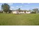 Single-story home with green lawn and mulch landscaping, paired with light beige stucco siding and long driveway at 2412 15Th W St, Palmetto, FL 34221