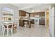 Bright kitchen with white appliances, wood cabinetry, and a breakfast bar for casual dining at 2412 15Th W St, Palmetto, FL 34221