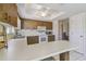 Cozy kitchen with wood cabinets, white appliances, and breakfast bar seating at 2412 15Th W St, Palmetto, FL 34221
