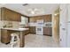 Full kitchen with breakfast bar, ceiling fan and tile flooring at 2412 15Th W St, Palmetto, FL 34221