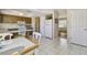 Open concept kitchen with wood cabinets, white appliances, and easy access to the living area at 2412 15Th W St, Palmetto, FL 34221