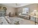 Inviting living room with comfortable seating, neutral carpeting, and bright natural light from the window at 2412 15Th W St, Palmetto, FL 34221