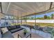 Enjoy this covered patio with neutral outdoor furniture and a view of the green backyard with white vinyl fencing at 2833 Sunnyside St, Sarasota, FL 34239