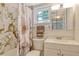 Bright bathroom with floral shower curtain and matching towels at 3108 Lake Bayshore Dr # 211, Bradenton, FL 34205