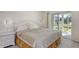 Bright bedroom with a large bed, a nightstand, and a sliding door that leads to the lanai at 3108 Lake Bayshore Dr # 211, Bradenton, FL 34205