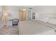 Bright bedroom features a desk, ensuite access, and stylish herringbone flooring at 3108 Lake Bayshore Dr # 211, Bradenton, FL 34205