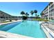 Sparkling community pool with lounge chairs and lake views, perfect for relaxing at 3108 Lake Bayshore Dr # 211, Bradenton, FL 34205