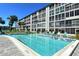 Sparkling community pool with lounge chairs for relaxing poolside at 3108 Lake Bayshore Dr # 211, Bradenton, FL 34205
