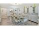 Dining room with modern table, chairs, and ample natural light at 3108 Lake Bayshore Dr # 211, Bradenton, FL 34205