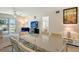 Dining room overlooking the open-concept living space, with view of the water from the sliding glass door at 3108 Lake Bayshore Dr # 211, Bradenton, FL 34205