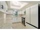 Modern kitchen with white cabinets, stainless steel appliances, and granite countertops at 3108 Lake Bayshore Dr # 211, Bradenton, FL 34205