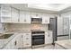 Kitchen with stainless appliances, granite countertops, and ample cabinet space at 3108 Lake Bayshore Dr # 211, Bradenton, FL 34205