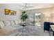 Comfortable living room with a large window showing building exterior and partial views of the lawn outside at 3108 Lake Bayshore Dr # 211, Bradenton, FL 34205