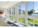 Sunroom with walls of windows offering water and green space views at 3108 Lake Bayshore Dr # 211, Bradenton, FL 34205