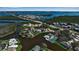 Aerial view of waterfront community with lush landscaping and bridge access at 318 108Th St W # 318, Bradenton, FL 34209
