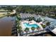 Aerial view showcasing the community pool and waterfront views surrounded by lush landscaping at 318 108Th St W # 318, Bradenton, FL 34209