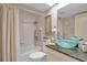 Bright bathroom featuring a tub with curtain and vanity with glass bowl sink and granite countertop at 318 108Th St W # 318, Bradenton, FL 34209