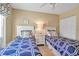 Cozy bedroom featuring two beds with stylish blue and white patterned bedding and matching nightstands at 318 108Th St W # 318, Bradenton, FL 34209