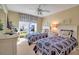 Bright bedroom with two twin beds, matching nightstands, and a window with patterned curtains at 318 108Th St W # 318, Bradenton, FL 34209