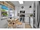 Modern kitchen with white cabinets, stainless steel appliances, and adjacent dining area at 318 108Th St W # 318, Bradenton, FL 34209