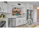 Stylish kitchen featuring stainless steel appliances, modern sink, and white cabinetry at 318 108Th St W # 318, Bradenton, FL 34209