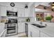 Contemporary kitchen with stainless appliances, white cabinets, and sleek countertops at 318 108Th St W # 318, Bradenton, FL 34209