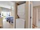 View through doorway to Laundry with stacked washer/dryer. Bedroom with two beds is in background at 318 108Th St W # 318, Bradenton, FL 34209