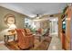 Living room featuring tile floors, comfortable seating, and open view to kitchen and bath at 318 108Th St W # 318, Bradenton, FL 34209