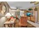Cozy living room features a plush sofa, an entertainment center, and plenty of natural light at 318 108Th St W # 318, Bradenton, FL 34209