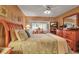 Serene main bedroom showcasing a comfortable queen bed, warm lighting, and connecting to the dining area at 318 108Th St W # 318, Bradenton, FL 34209