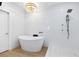 Elegant bathroom showcasing a freestanding tub, modern shower with a statement chandelier at 340 Gulf Of Mexico Dr # 115, Longboat Key, FL 34228