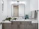 Modern bathroom with gray vanity, white countertop, and decorative accents at 340 Gulf Of Mexico Dr # 115, Longboat Key, FL 34228