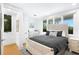 Bright bedroom featuring contemporary decor, large windows and neutral color scheme at 340 Gulf Of Mexico Dr # 115, Longboat Key, FL 34228