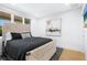 Bright bedroom featuring contemporary decor, large windows, abstract artwork and neutral color scheme at 340 Gulf Of Mexico Dr # 115, Longboat Key, FL 34228