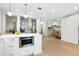 Open-concept kitchen with a view to the office and featuring white cabinetry and stainless steel appliances at 340 Gulf Of Mexico Dr # 115, Longboat Key, FL 34228