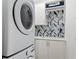 Well-equipped laundry room with modern washer/dryer and designer tile backsplash at 340 Gulf Of Mexico Dr # 115, Longboat Key, FL 34228