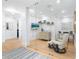 Home office with glass doors, modern decor, a comfortable chair, and beach-themed TV display at 340 Gulf Of Mexico Dr # 115, Longboat Key, FL 34228