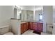 Bathroom featuring double sinks, granite countertops, and a separate shower at 3478 Parkridge Cir # 32-104, Sarasota, FL 34243