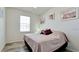 Cozy bedroom features a window, wood-look floors, and two twin beds dressed with pillows at 3478 Parkridge Cir # 32-104, Sarasota, FL 34243