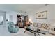 Open concept living room featuring tile flooring, a bar, and lots of natural light at 3478 Parkridge Cir # 32-104, Sarasota, FL 34243