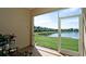 A screened patio offers a tranquil view of the pond and surrounding landscaping at 3478 Parkridge Cir # 32-104, Sarasota, FL 34243
