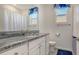 Bathroom featuring granite vanity, a mirror, and blue accents at 427 157Th E Ct, Bradenton, FL 34212