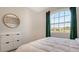 Bedroom with view, decorative wallpaper, and ample natural light at 427 157Th E Ct, Bradenton, FL 34212