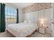 Comfortable bedroom with a large window and stylish accent wall at 427 157Th E Ct, Bradenton, FL 34212