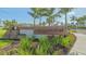 Attractive community sign featuring a wood background and stacked stone accent under mature palm trees at 427 157Th E Ct, Bradenton, FL 34212