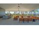 Outdoor pavilion featuring ample seating, ceiling fans, and a grilling area overlooking landscaped surroundings at 427 157Th E Ct, Bradenton, FL 34212
