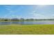 Scenic backyard overlooking a tranquil lake, providing a serene and picturesque setting at 427 157Th E Ct, Bradenton, FL 34212