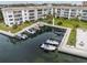Aerial view of condominiums featuring boat docks, manicured lawns, and lush landscaping at 4310 Falmouth Dr # 304, Longboat Key, FL 34228