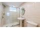 Bright bathroom featuring a tiled walk-in shower, pedestal sink, and modern fixtures at 4310 Falmouth Dr # 304, Longboat Key, FL 34228